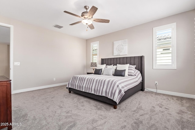 carpeted bedroom with baseboards and a ceiling fan