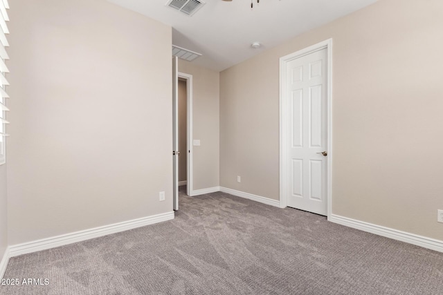 unfurnished room featuring carpet, a ceiling fan, and baseboards