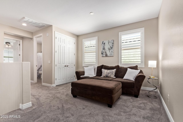 living room with carpet floors, plenty of natural light, and baseboards