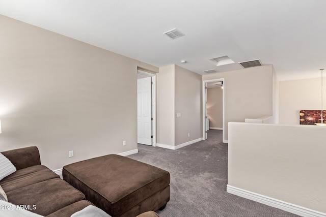 living room featuring dark colored carpet and baseboards