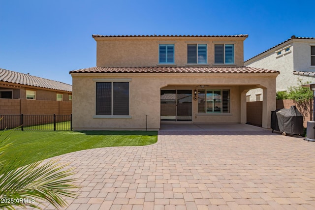 back of house with a patio area and stucco siding