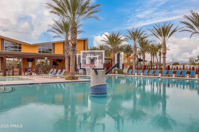 community pool featuring fence and a patio