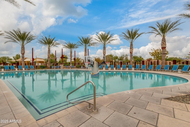 community pool featuring a patio and fence