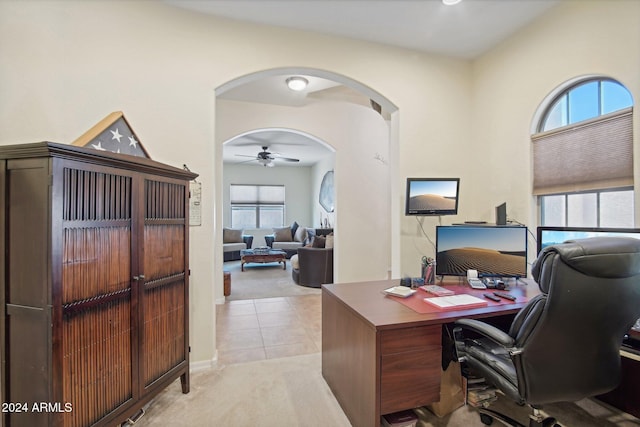 office space with ceiling fan and light colored carpet