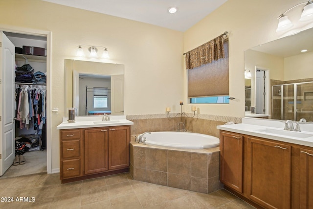 bathroom featuring tile patterned floors, vanity, and plus walk in shower