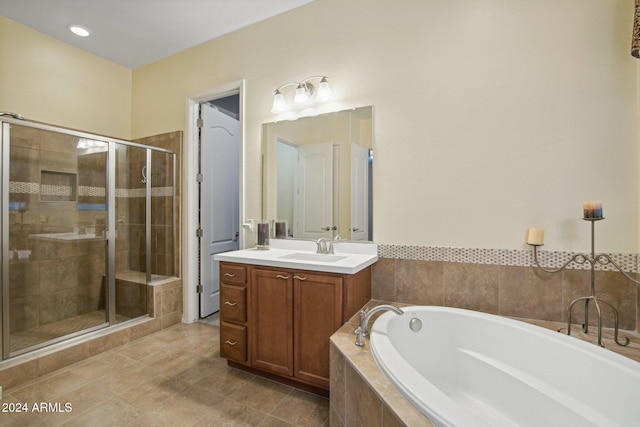 bathroom featuring tile patterned floors, vanity, and separate shower and tub