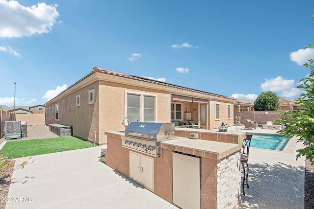 view of patio / terrace featuring an outdoor kitchen, a fenced in pool, and grilling area