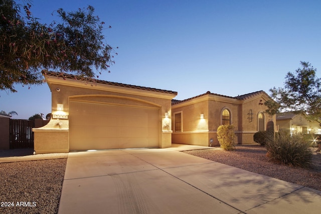 mediterranean / spanish-style house with a garage