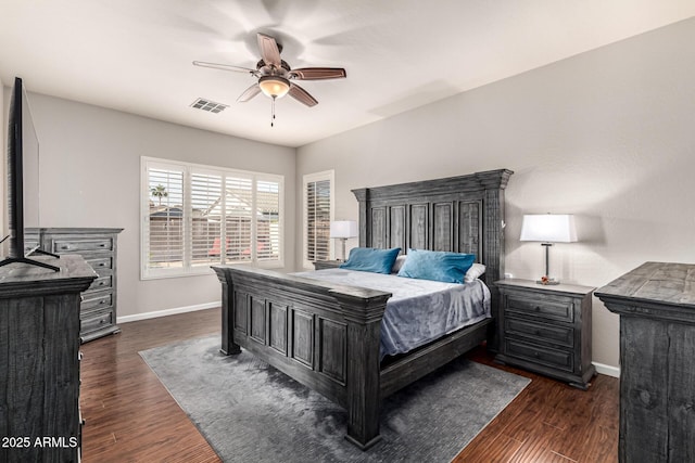 bedroom with baseboards, dark wood-type flooring, and a ceiling fan