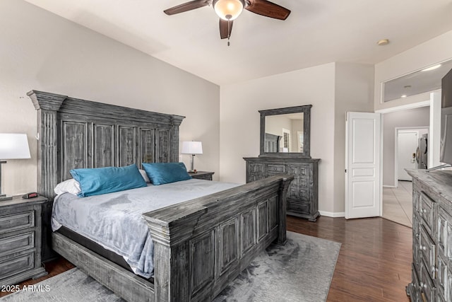 bedroom with a ceiling fan, wood finished floors, and baseboards
