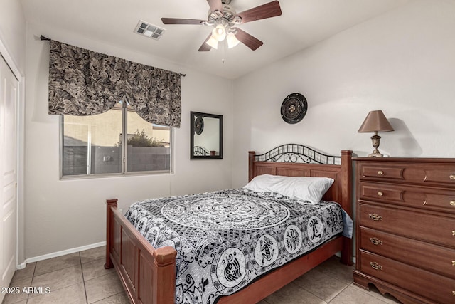 bedroom with baseboards, light tile patterned floors, and ceiling fan