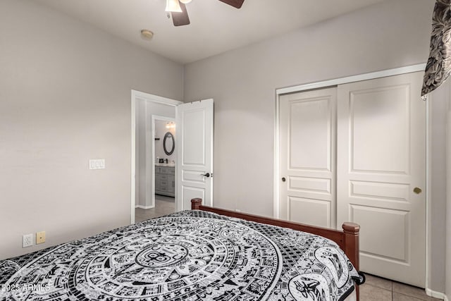 bedroom featuring light tile patterned flooring, a closet, and ceiling fan