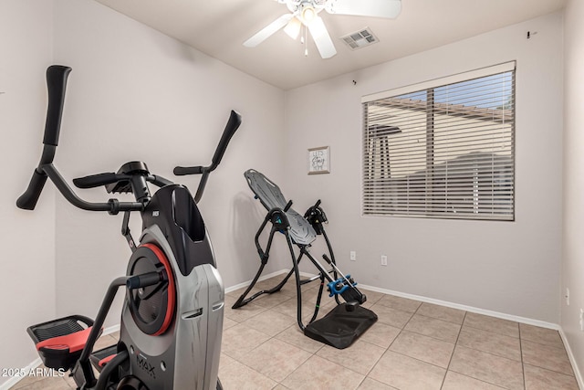 exercise room featuring ceiling fan, baseboards, and light tile patterned floors