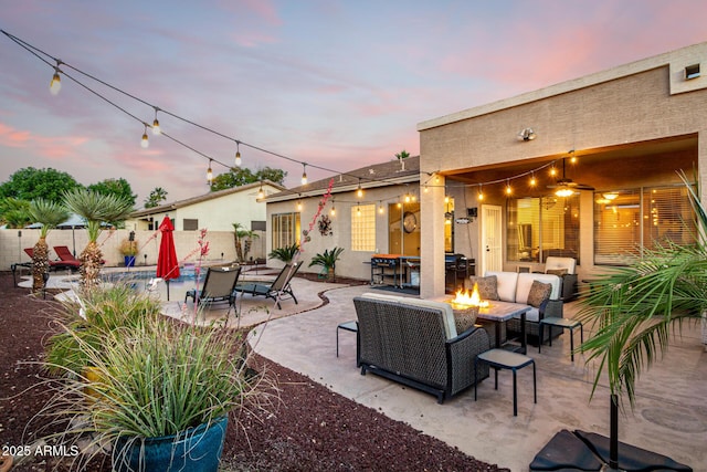 view of patio with an outdoor living space with a fire pit and fence