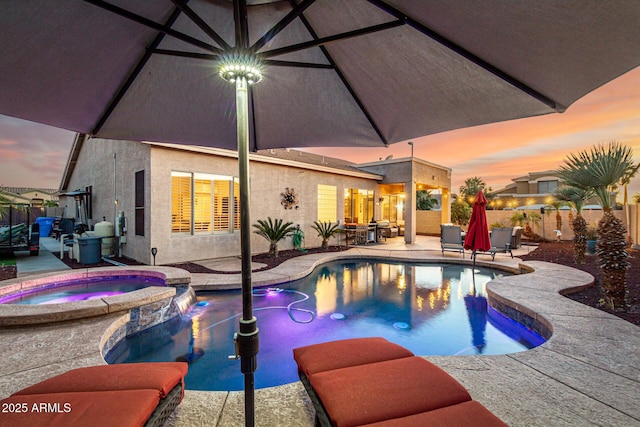view of pool with a patio, a fenced backyard, and a pool with connected hot tub