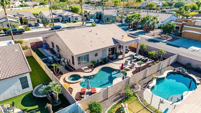 aerial perspective of suburban area featuring a pool