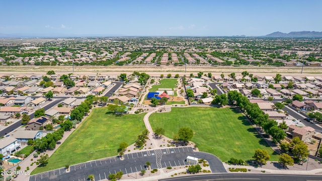 aerial overview of property's location with a mountain backdrop and nearby suburban area