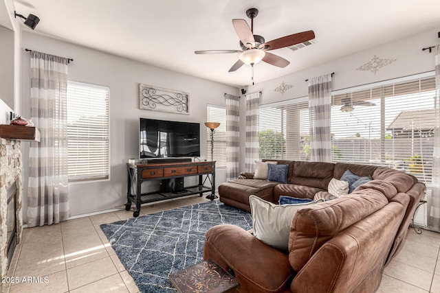 tiled living area featuring ceiling fan