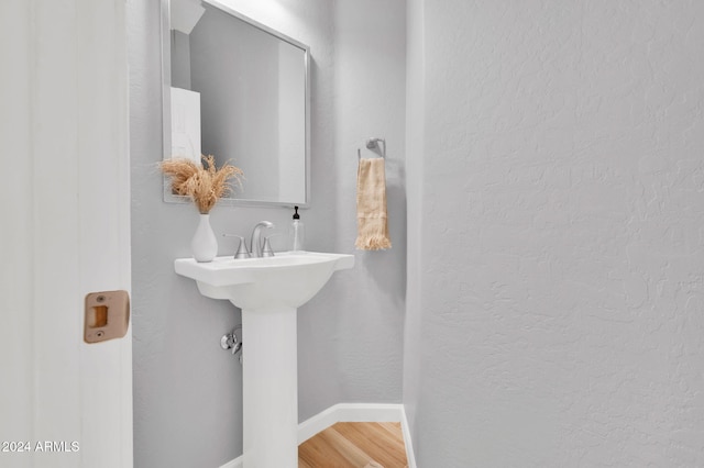 bathroom with wood-type flooring