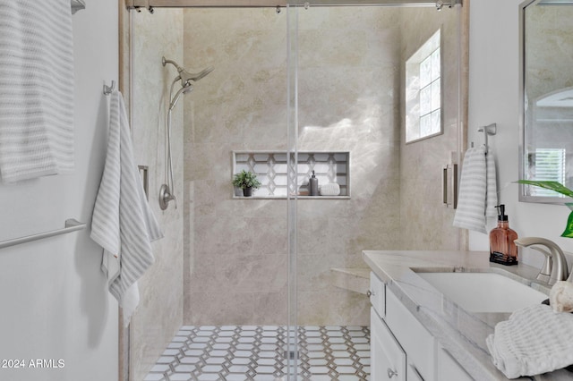 bathroom with vanity and a shower with door