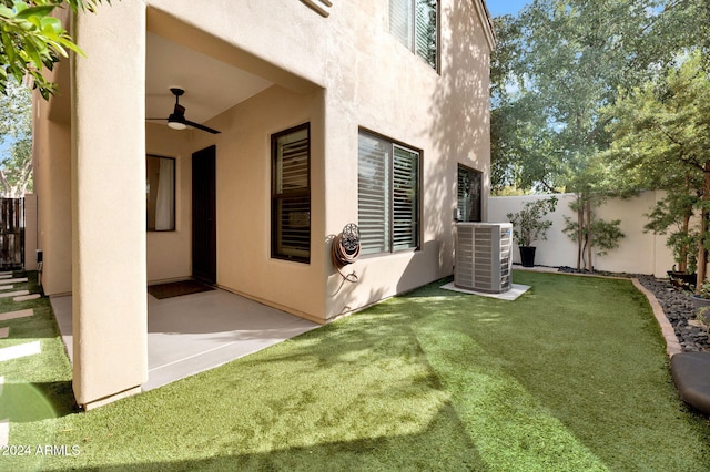 view of yard featuring ceiling fan, central AC, and a patio area