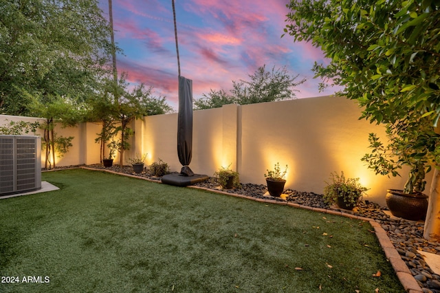 yard at dusk with cooling unit