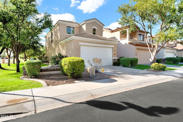 view of front of property with a garage and a front lawn