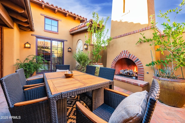 view of patio with an outdoor brick fireplace