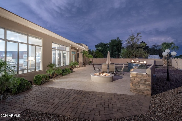 patio terrace at dusk with a fire pit