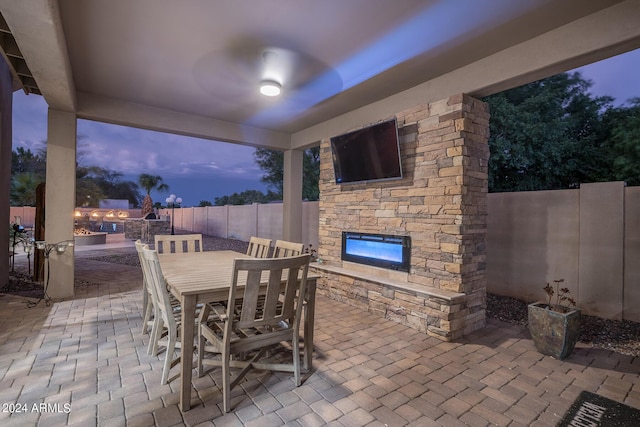 view of patio / terrace featuring an outdoor stone fireplace