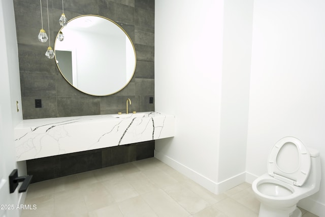 bathroom with tile patterned flooring, sink, and toilet