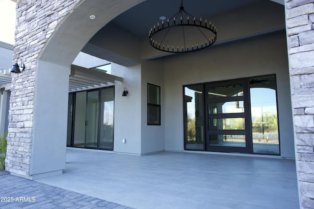 entrance to property featuring a patio area