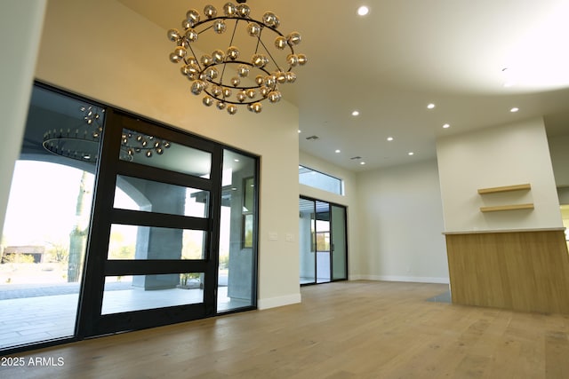 interior space featuring hardwood / wood-style flooring and a notable chandelier