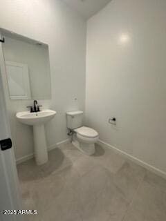 25336 W Bowker St, Buckeye, AZ 85326 - half bath with tile patterned flooring, baseboards, toilet, and lofted ceiling