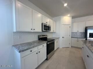 25336 W Bowker St, Buckeye, AZ 85326 - kitchen featuring white cabinets, recessed lighting, stainless steel appliances, decorative backsplash, and stone countertops