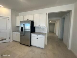 25336 W Bowker St, Buckeye, AZ 85326 - kitchen featuring white cabinetry and stainless steel refrigerator with ice dispenser