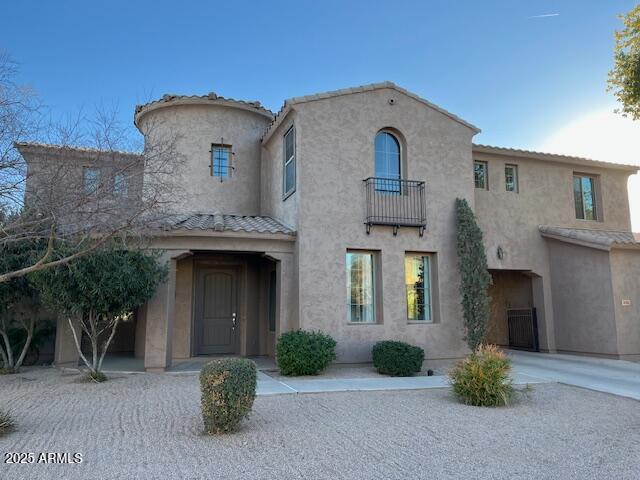 mediterranean / spanish home with a balcony