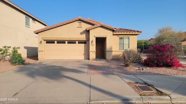 6820 S 68th Ln, Laveen, AZ 85339 - view of front of home featuring a tile roof, stucco siding, driveway, and an attached garage