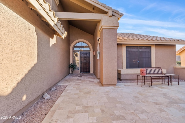 doorway to property featuring a patio