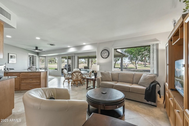 living room with light tile patterned floors, visible vents, recessed lighting, and a ceiling fan