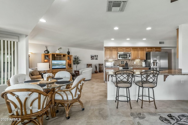 dining room with recessed lighting and visible vents