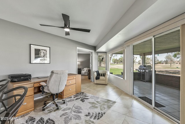 home office featuring light tile patterned floors, a ceiling fan, and vaulted ceiling