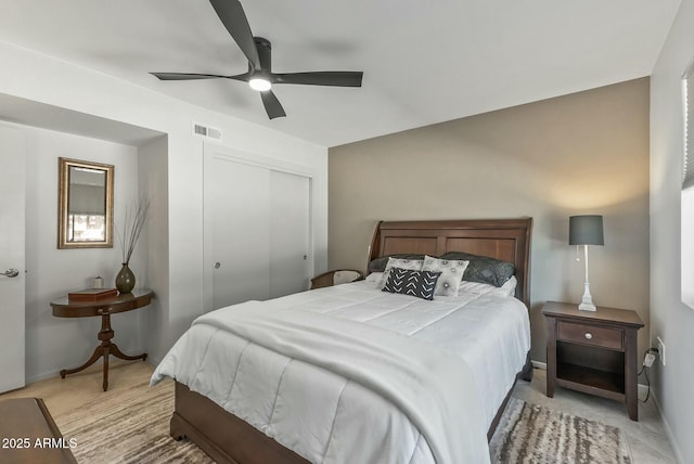 bedroom featuring baseboards, visible vents, a closet, and ceiling fan