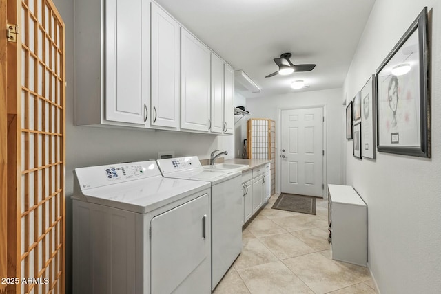 laundry room with a ceiling fan, a sink, washer and dryer, cabinet space, and light tile patterned floors