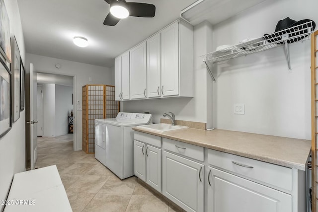 laundry area with cabinet space, washer and dryer, a ceiling fan, and a sink