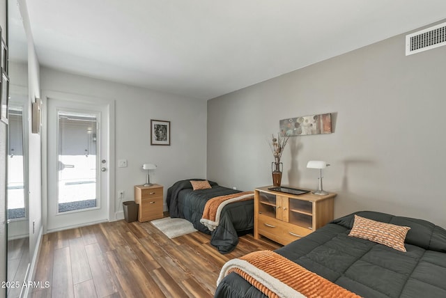 bedroom featuring visible vents and wood finished floors