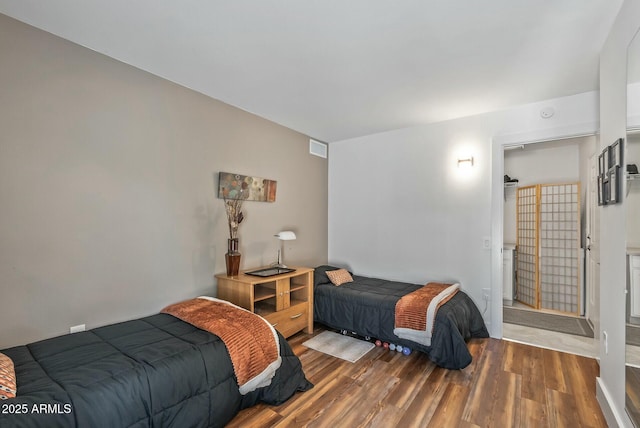 bedroom with wood finished floors and visible vents