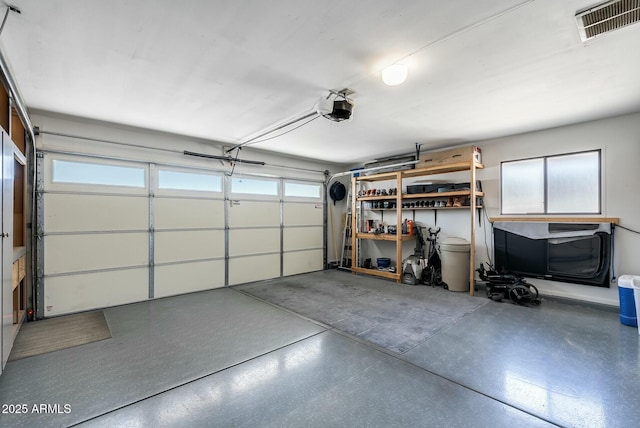 garage with visible vents and a garage door opener