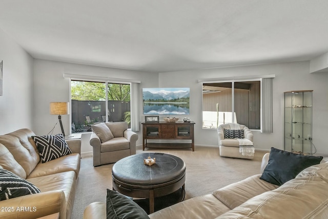 carpeted living room featuring baseboards