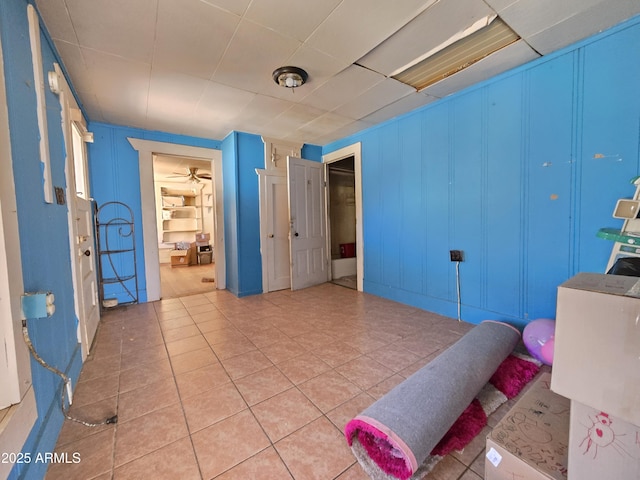 tiled bedroom featuring a decorative wall